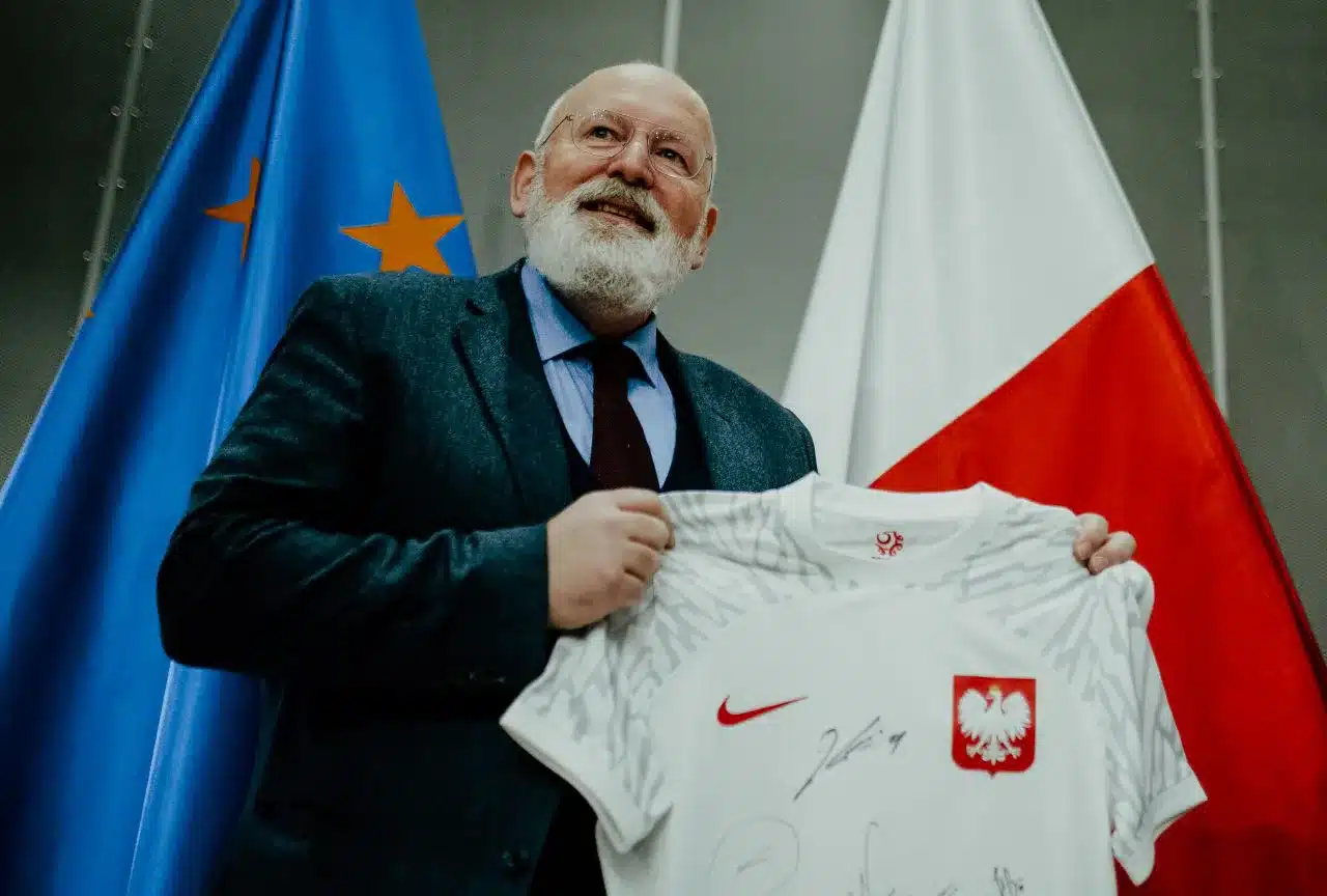 frans timmermans holding a Polish national football jersey