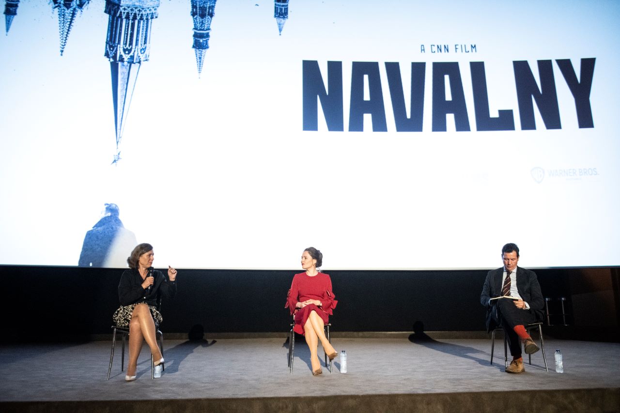 Vĕra Jourová, Maria Pevchikh, Matthew Chance in front of a cinema scree,